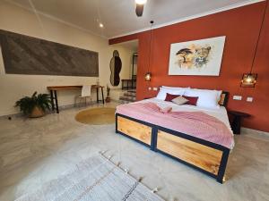a bedroom with a bed with a red wall at Villa Miamba in Zame +9 photos