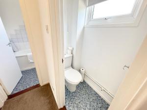 a bathroom with a toilet and a window at Large 2 bedroom house in Wombridge +24 photos