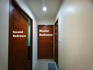 a hallway with a door and a master bathroom at The Two bedrooms Two bathrooms in Phuket Old Town in Phuket