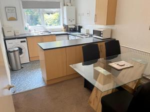 a kitchen with a table and a counter top at Large 2 bedroom house in Wombridge