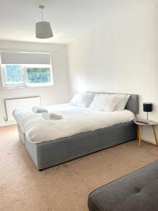 a bedroom with a large bed in a room at Large 2 bedroom house in Wombridge