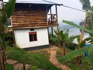 a small house on top of a hill at Weaver Bird Hostel in Rubanda +17 photos