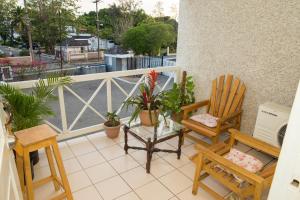 a balcony with two chairs and potted plants on it at Cozy Waterloo Apartment in Kingston