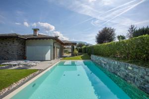 a swimming pool in the backyard of a house at Villa Miraggio by MyVillaCollection in Tremezzo