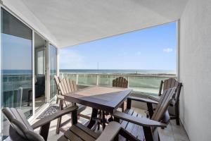 a dining room with a table and chairs on a balcony at Silver Beach 104 PET FRIENDLY! in Orange Beach