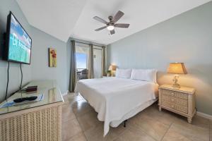 a bedroom with a bed and a flat screen tv at Silver Beach 104 PET FRIENDLY! in Orange Beach