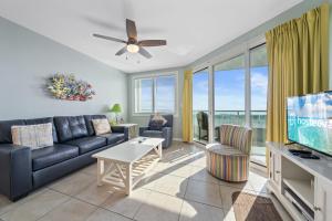 a living room with a couch and a tv at Silver Beach 104 PET FRIENDLY! in Orange Beach
