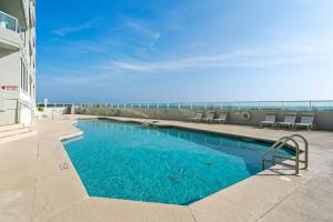 a swimming pool on the side of a building at Silver Beach 104 PET FRIENDLY! in Orange Beach