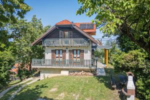 an image of a house with a large deck at Vineyard Cottage Vrbek in Roginska Gorca