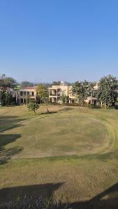a golf course with a hole in the grass at Cocoa Bliss in Manesar