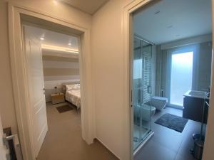 a bathroom with a glass door leading to a bedroom at Sul VenTo del Po in Melara +127 photos