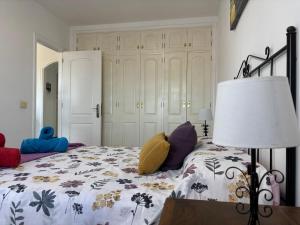 a bedroom with a bed and a lamp with pillows on it at Panoramic View Balcón del Atlántico in Adeje +18 photos