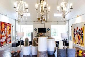 a living room with chandeliers and a table with candles at The Bay Cottage in Pringle Bay