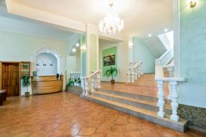 a lobby with stairs and a chandelier at Centralny Hotel in Kryvyi Rih