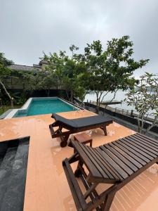 a picnic table and a bench next to a pool at Charlie in Ambalangoda