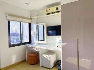 a room with a white desk and a window at Klongrien Boutique Hotel in Hat Yai