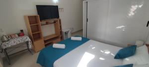 a small room with a bed and a television at Sunlight house in Marsaskala