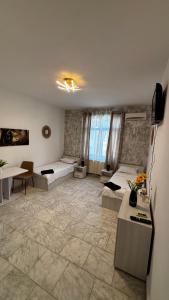 a room with two beds and a table in it at MLR Residence - Free Private Parking in Timişoara