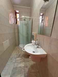 a bathroom with a sink and a shower at MLR Residence - Free Private Parking in Timişoara