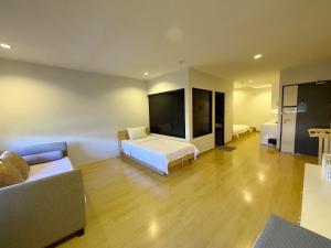 a hotel room with a bed and a couch at Klongrien Boutique Hotel in Hat Yai