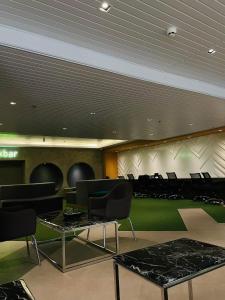 a conference room with black chairs and a green floor at Sweetluxx - SMDC Green 2 Residences Staycation in Dasmariñas +30 photos