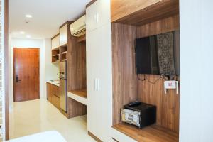 a living room with a tv and a room at AN Studio VVT in Ho Chi Minh City