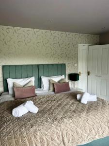 a large bed with two pillows on top of it at Alloa in Newby Bridge
