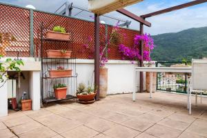 a balcony with potted plants on a building at Lisa's Stylish Top Floor Flat & Double Pool in Pietra Ligure