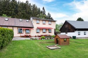 a house with a dog house in the yard at Apartmány Andrea s wellness in Zdíkov