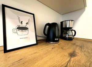 a picture of a cup of coffee and a blender at ODA Living Lüneburg in Lüneburg