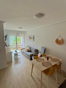 a living room with a table and a couch at Sunny Escape in El Campello in El Campello