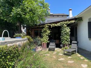 a house with two chairs and a patio at Charming villa with a private pool in Las Rozas de Madrid