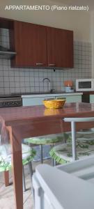 a kitchen with a wooden table with a bowl on it at Dimora Nonna Angela in Alberobello +30 photos
