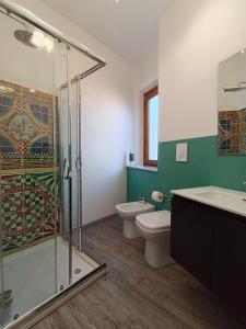 a bathroom with a shower and a toilet and a sink at B&B A' Kiazza in Buompietro +43 photos