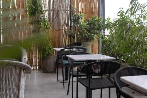 a row of tables and chairs in a restaurant at Hamsun Shahrah-e-Faisal in Karachi