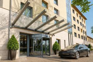 a car parked in front of a building at CZECH INN Hotel Ferenc in Budapest