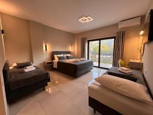 a hotel room with two beds and a window at The Mark Hotel in Gliki