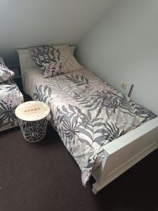 a bedroom with a bed and a small table at Paula Apart in Wadowice