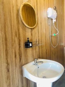 a bathroom with a white sink and a mirror at Maison MAY Đà Lạt in Da Lat +21 photos