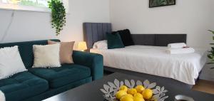 a living room with a couch and a bed at VESTA Apartamenty M52 Free parking in Szczecin