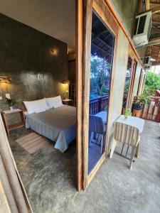 a bedroom with a bed and a mirror at Balay Yuhom in General Luna
