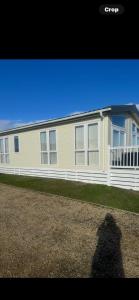 a shadow of a person standing in front of a house at Aurora luxury beach lodge in Lossiemouth