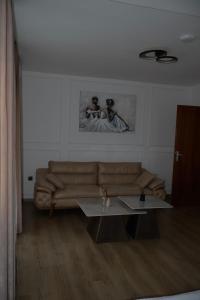 a living room with a couch and a table at Mas Motel in Bosanska Gradiška +16 photos