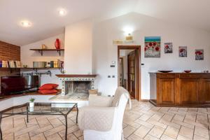 a living room with a couch and a fireplace at Italian Experience-Casa Miramonti in Perugia
