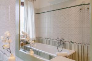 a bathroom with a tub and a mirror at Italian Experience-Casa Miramonti in Perugia +55 photos