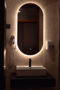 a bathroom with a sink and a mirror at Mas Motel in Bosanska Gradiška