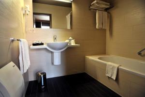 a bathroom with a sink and a bath tub at Flanders Hotel in Bruges +55 photos