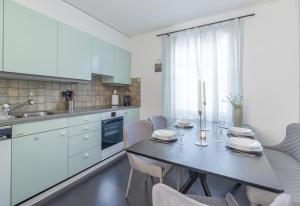 a kitchen with a dining table and chairs at WG Zimmer Seilerstrasse in Arbon