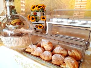 a bunch of breads in a tray on a counter at Villa Grazia Pompei in Pompei +21 photos