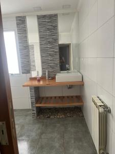 a bathroom with a sink and a mirror at dpto lofalu in Gobernador Gregores